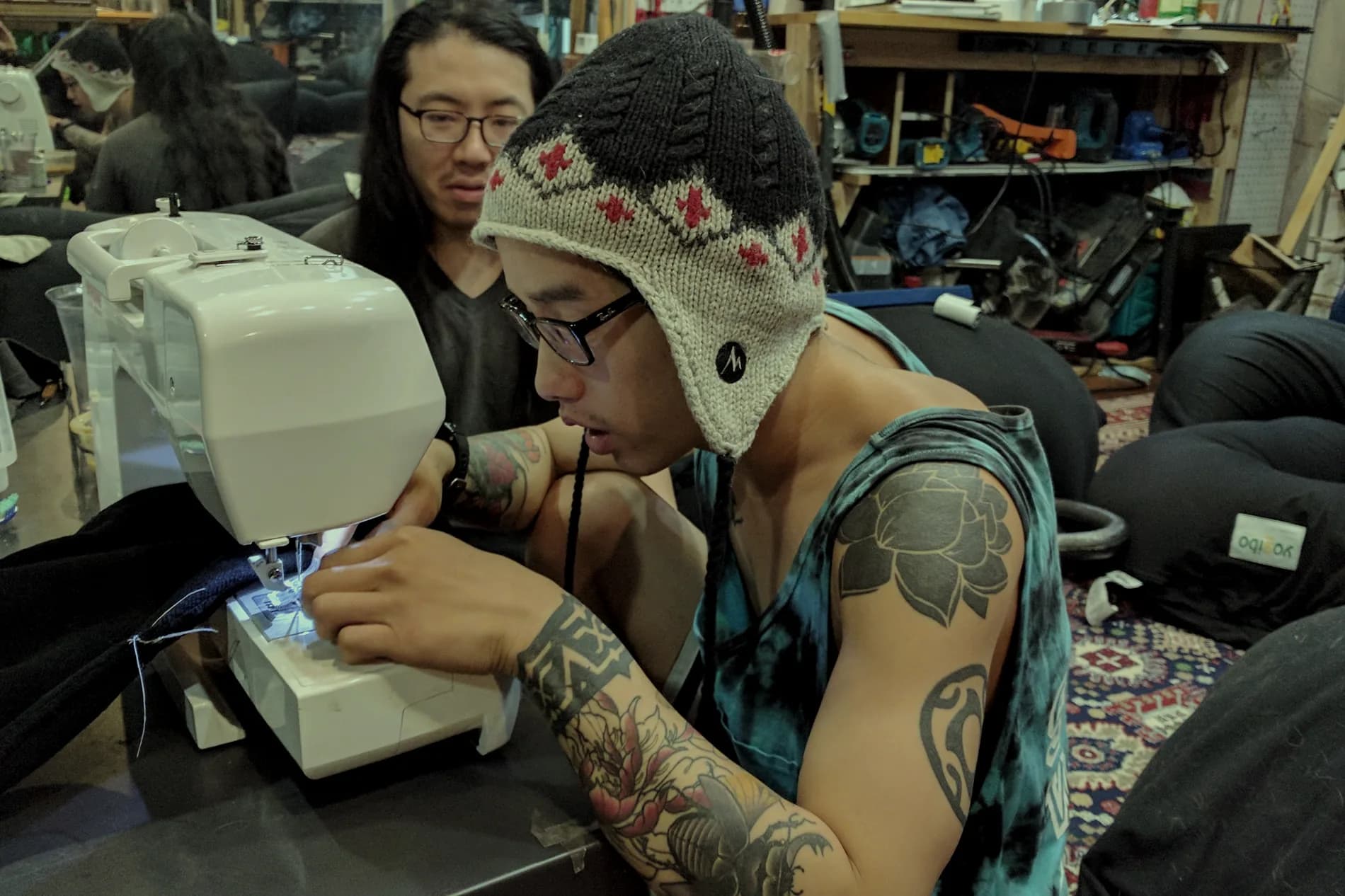 People working at sewing machines during a repair workshop
